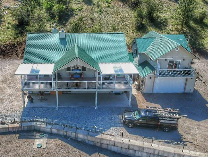 aerial of dual patio covers on large deck with tin roof