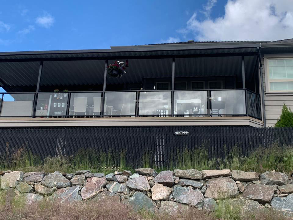 front of house with large patio cover with glass railings