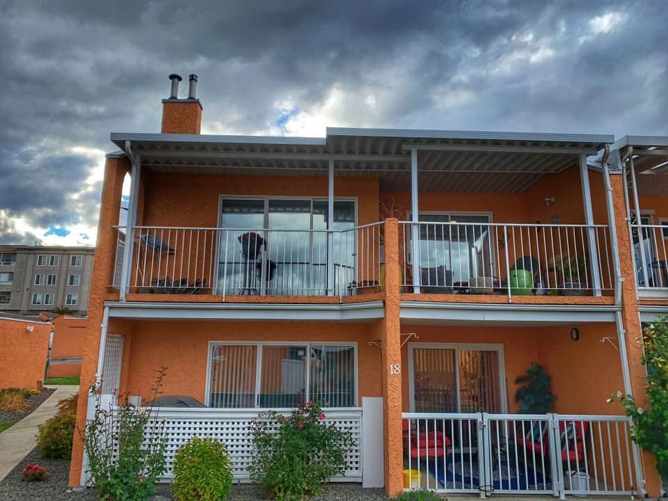 patio cover on deck of bright orange townhouse