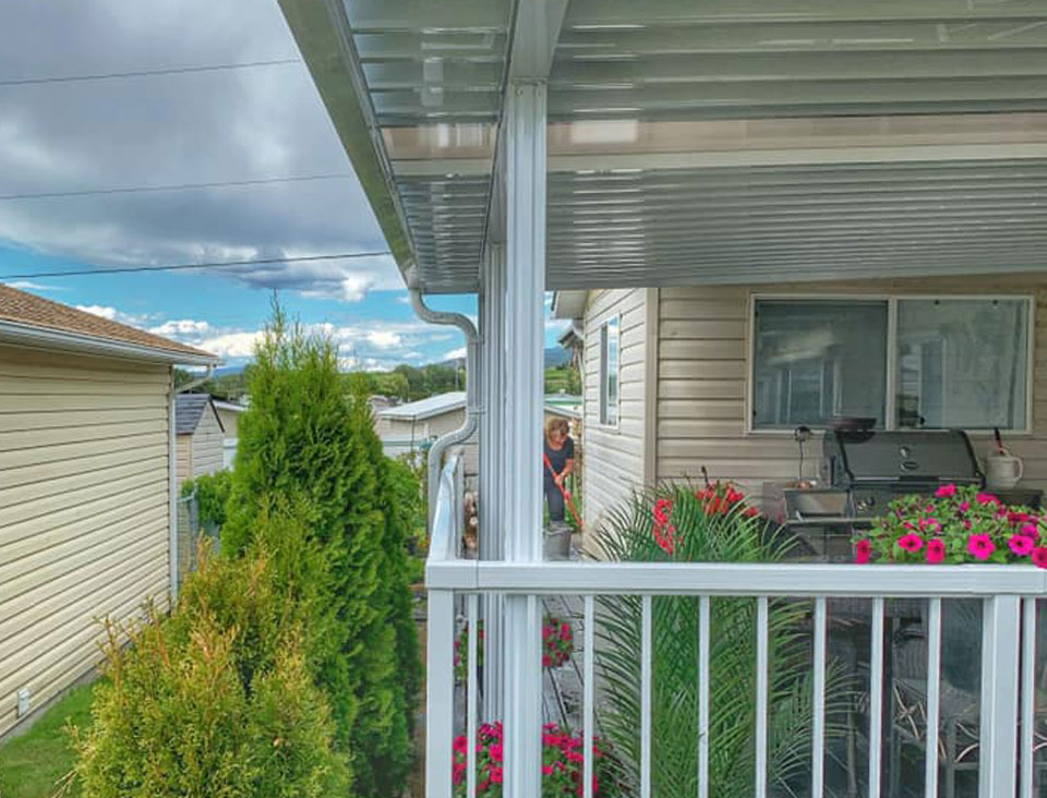 side of white patio cover on yellow house